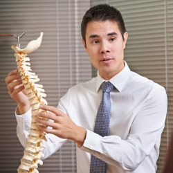 A photo of a man holding a spine.